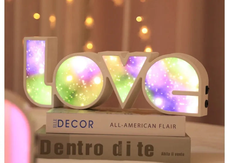 LED Love light with rainbow 'LOVE' lampshade on a table.