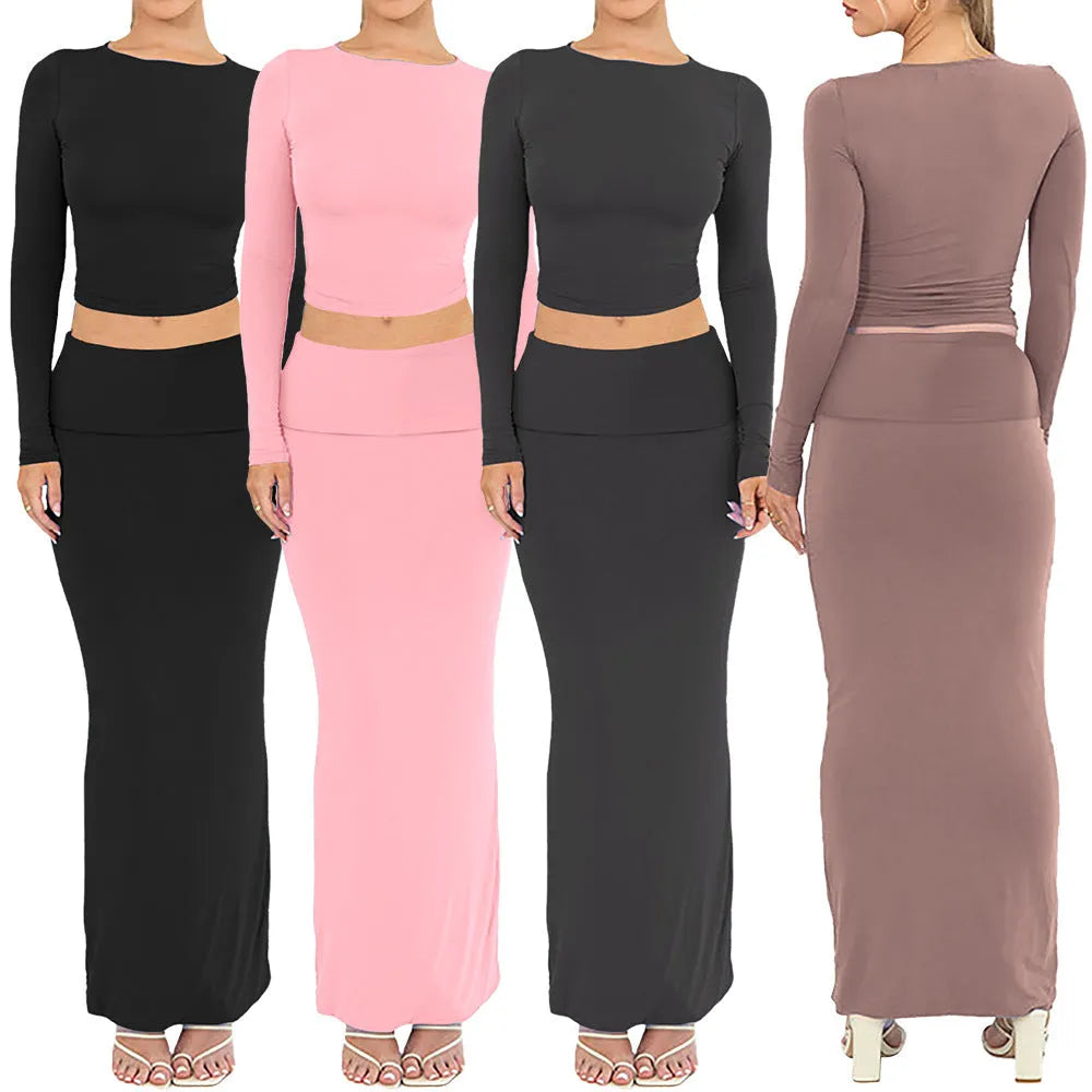 Women's slim fit polyester two-piece suit set with top, long skirt, and exposed navel detail.