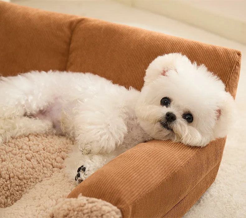 Small brown and grey fabric dog kennel bed with a plush cushion inside, showing its non-slip base.