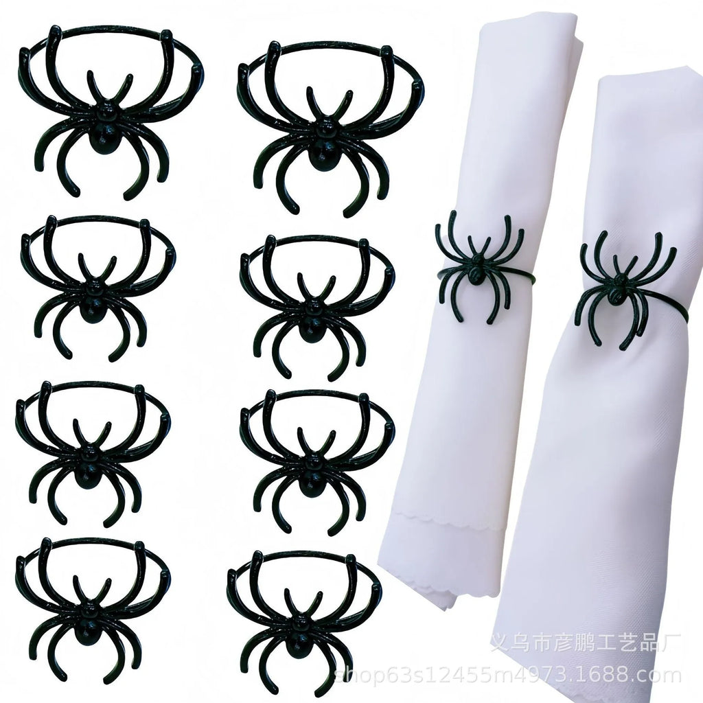 Set of six black alloy spider-shaped napkin rings for Halloween table decoration.