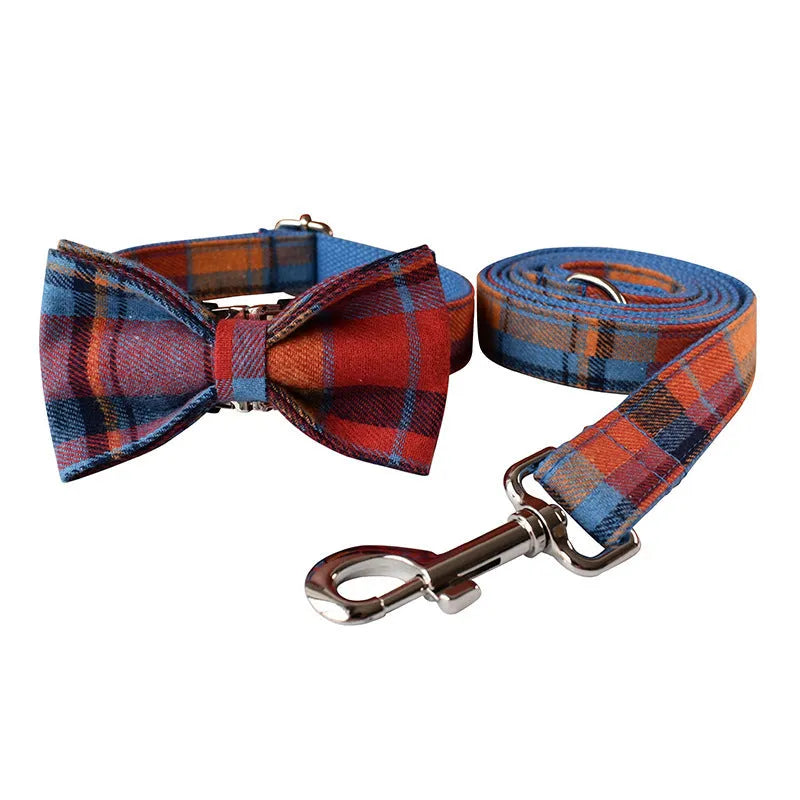 Blue background velvet plaid dog collar with a silver alloy metal buckle on a white surface.