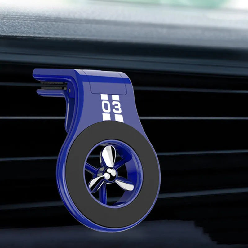 Black magnetic car phone holder with perfume slices, clipped on a car air vent