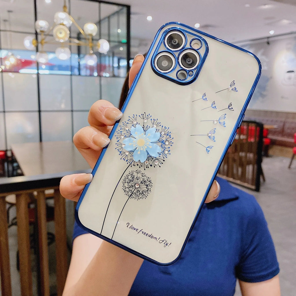 Purple silicone iPhone case with a 3D floral design and built-in spin stand on a table.
