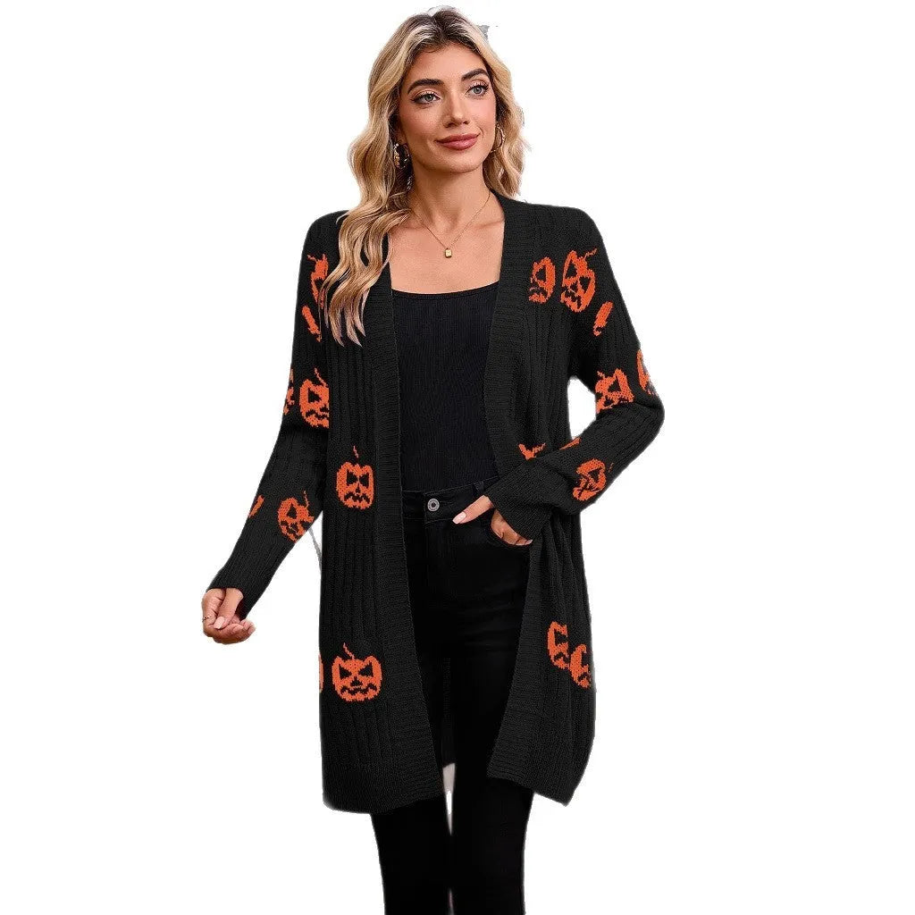 Women's black Halloween cardigan with orange pumpkin head jacquard pattern, shown as a medium-length knitted coat.
