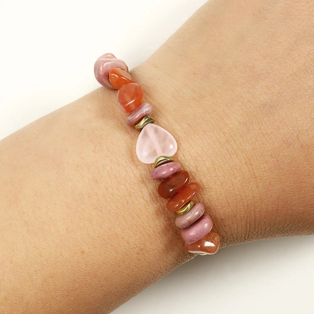 Handcrafted women's stone bracelet with geometric beads on a wrist.