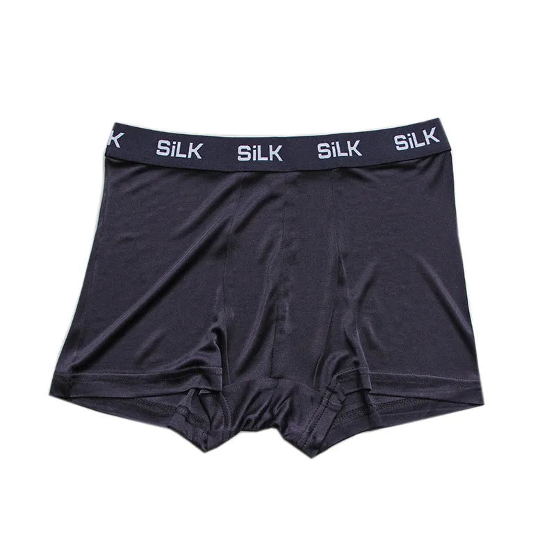 Men's loose-fitting silk shorts in navy blue, shown laid flat, featuring a mid waist and casual design.