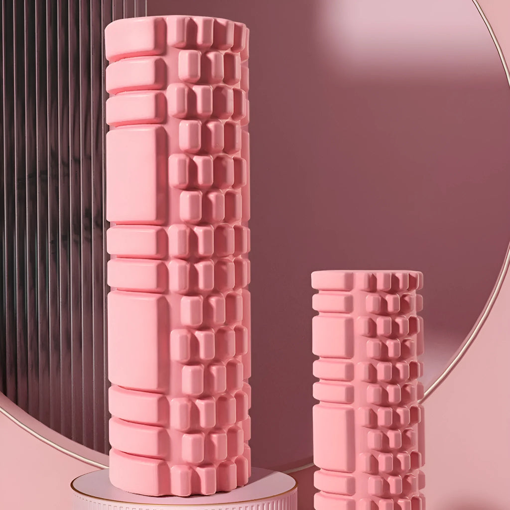 A black EVA foam roller on a gym floor, showing its cylindrical shape and texture.