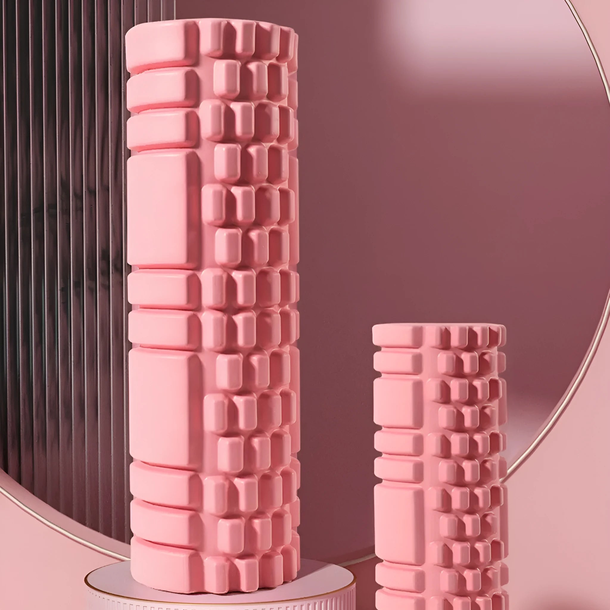 A black EVA foam roller on a gym floor, showing its cylindrical shape and texture.