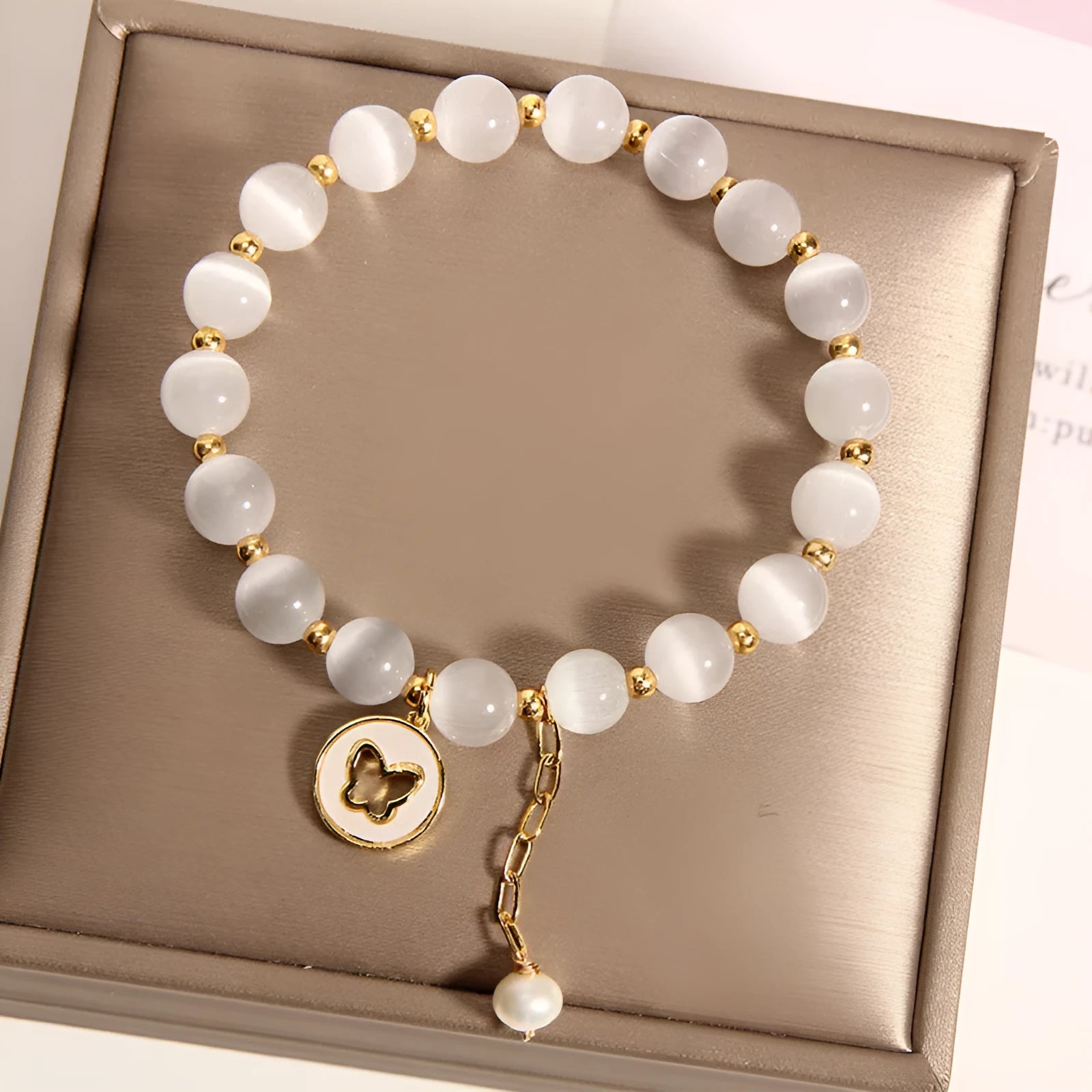 White geometric cat's eye crystal bracelet with a Korean-style design on a wrist.