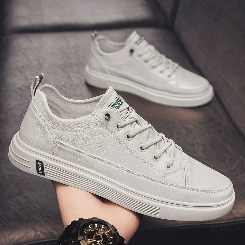 Men's casual white PU leather shoes with round toe and low flat heel on a beige background.