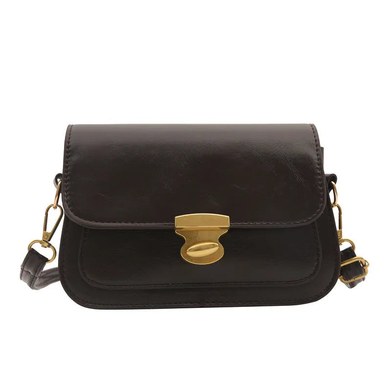 Soft PU leather small square handbag in horizontal rectangle shape shown in brown colour.