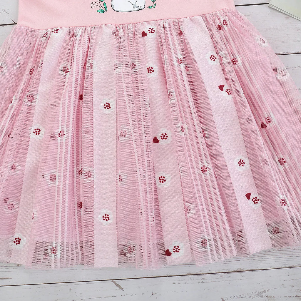 Pink cotton girls princess dress with cartoon rabbit print and mesh overlay on plain background