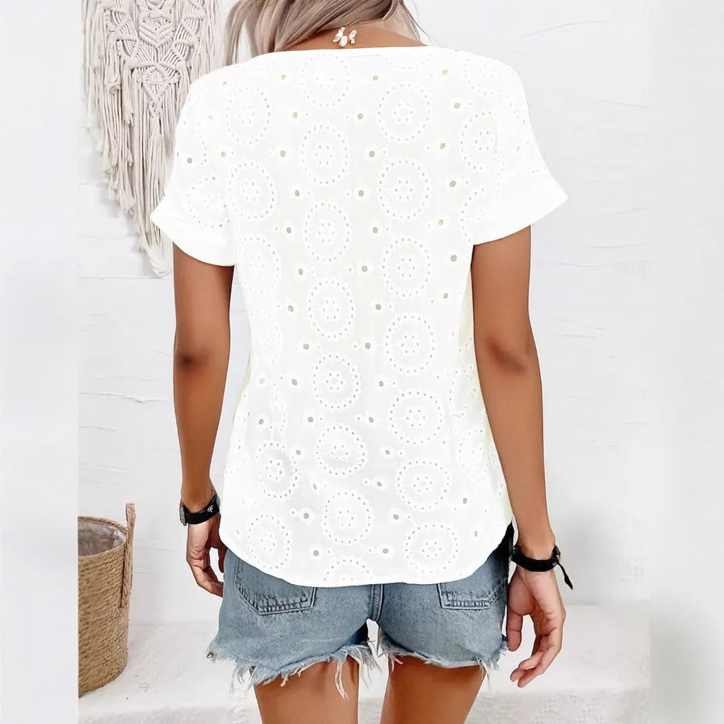 White women's loose V-neck T-shirt with hollow-out pattern detail on the front.