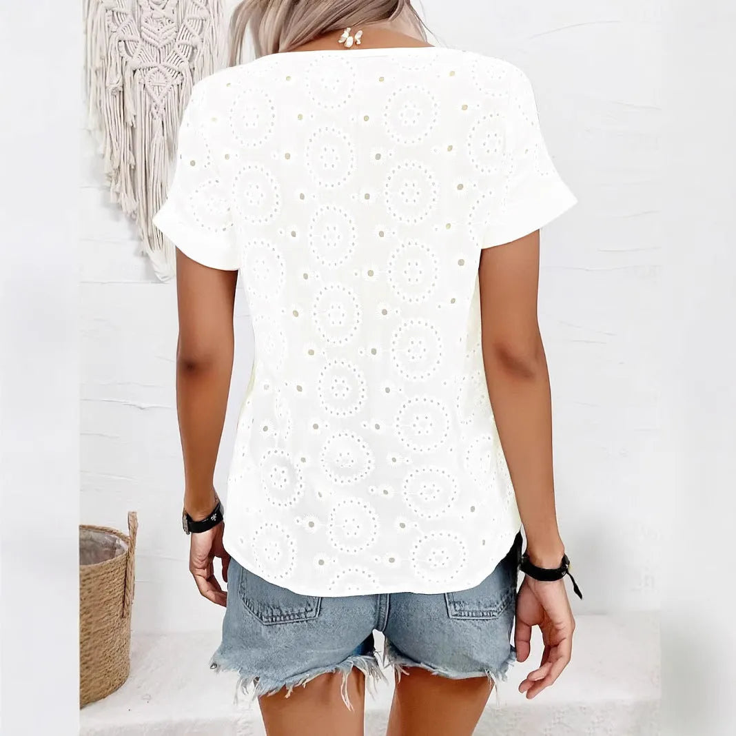 White women's loose V-neck T-shirt with hollow-out pattern detail on the front.