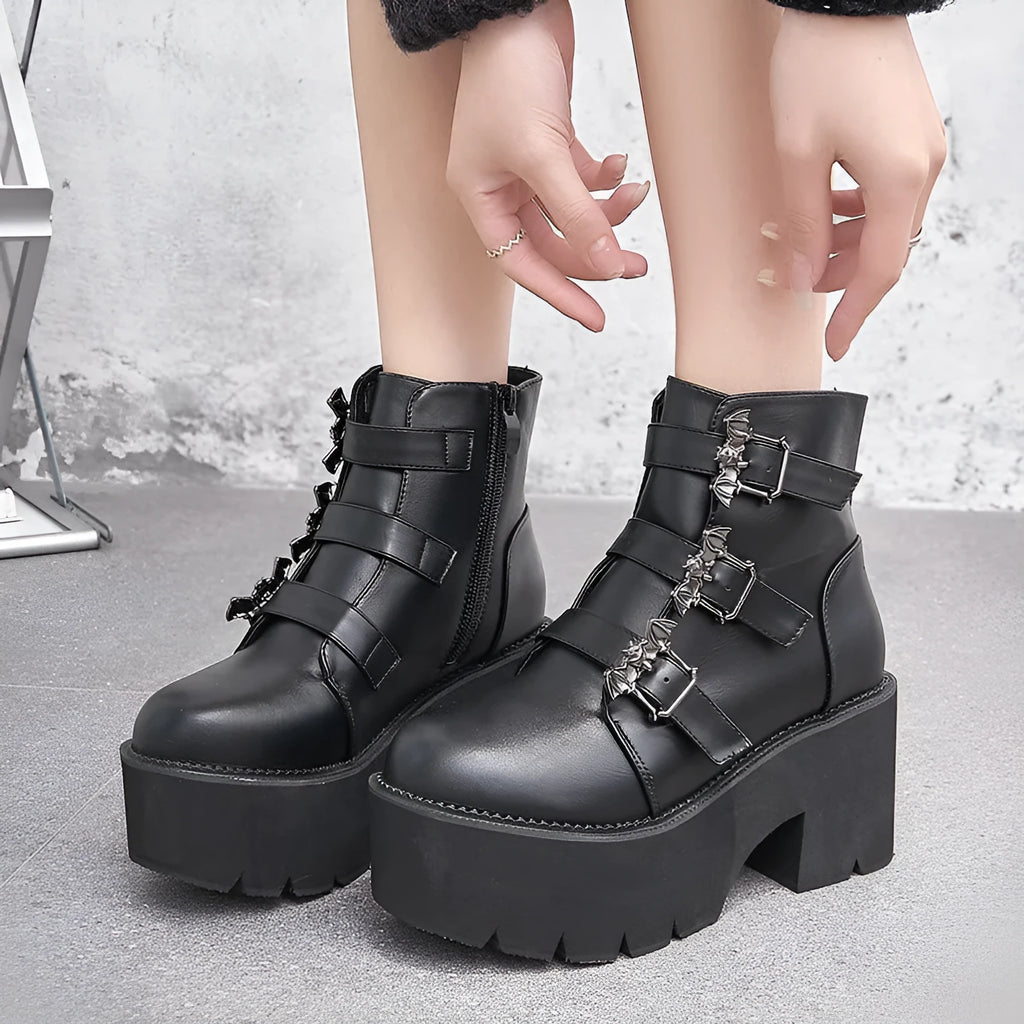 Black women's punk gothic ankle boots with bat buckle, side zipper, and chunky platform heel.