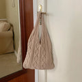 Retro hollow knitted woolen women's shoulder tote bag in a solid colour, showing double straps and large capacity.