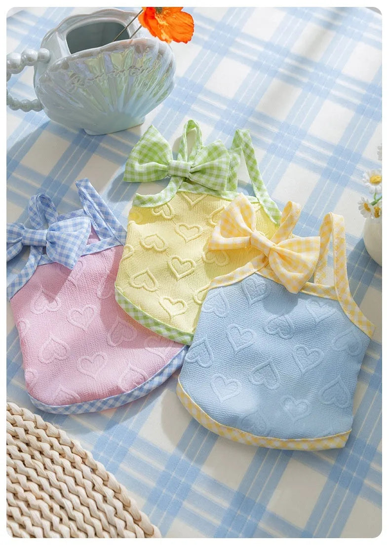 Small dog wearing heart texture bow suspenders vest in Bondi Blue colour