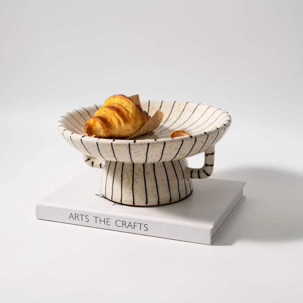 Black and white striped synthetic resin fruit dessert plate on a table