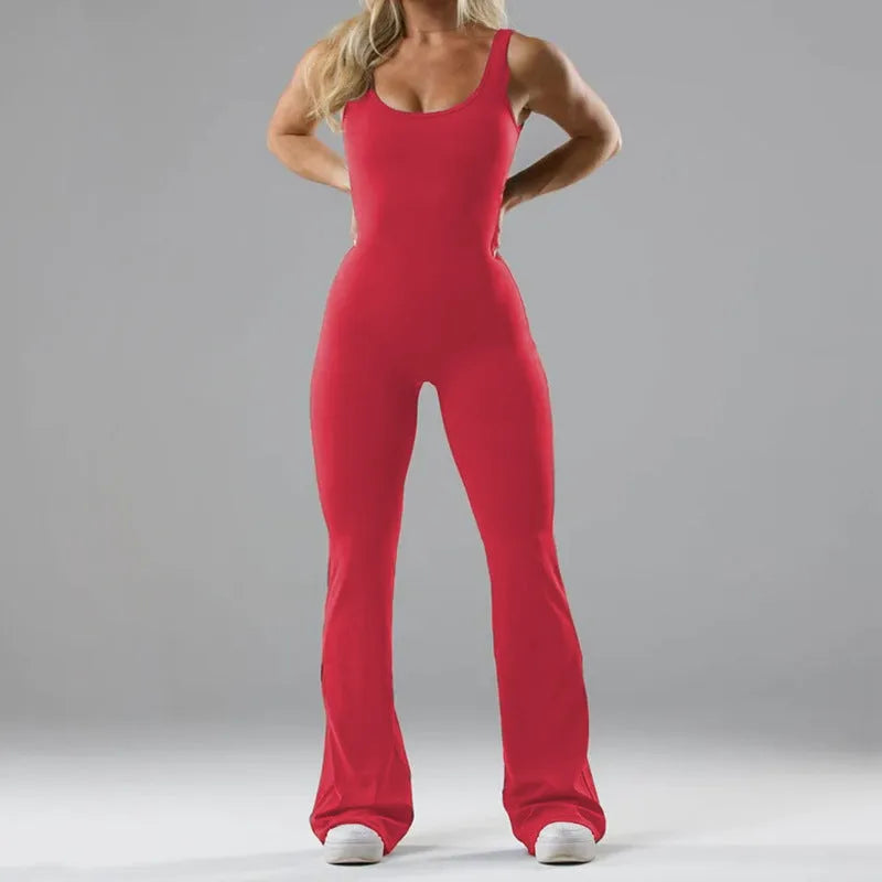 Black seamless women's yoga bodysuit jumpsuit with built-in chest pad, shown on model.
