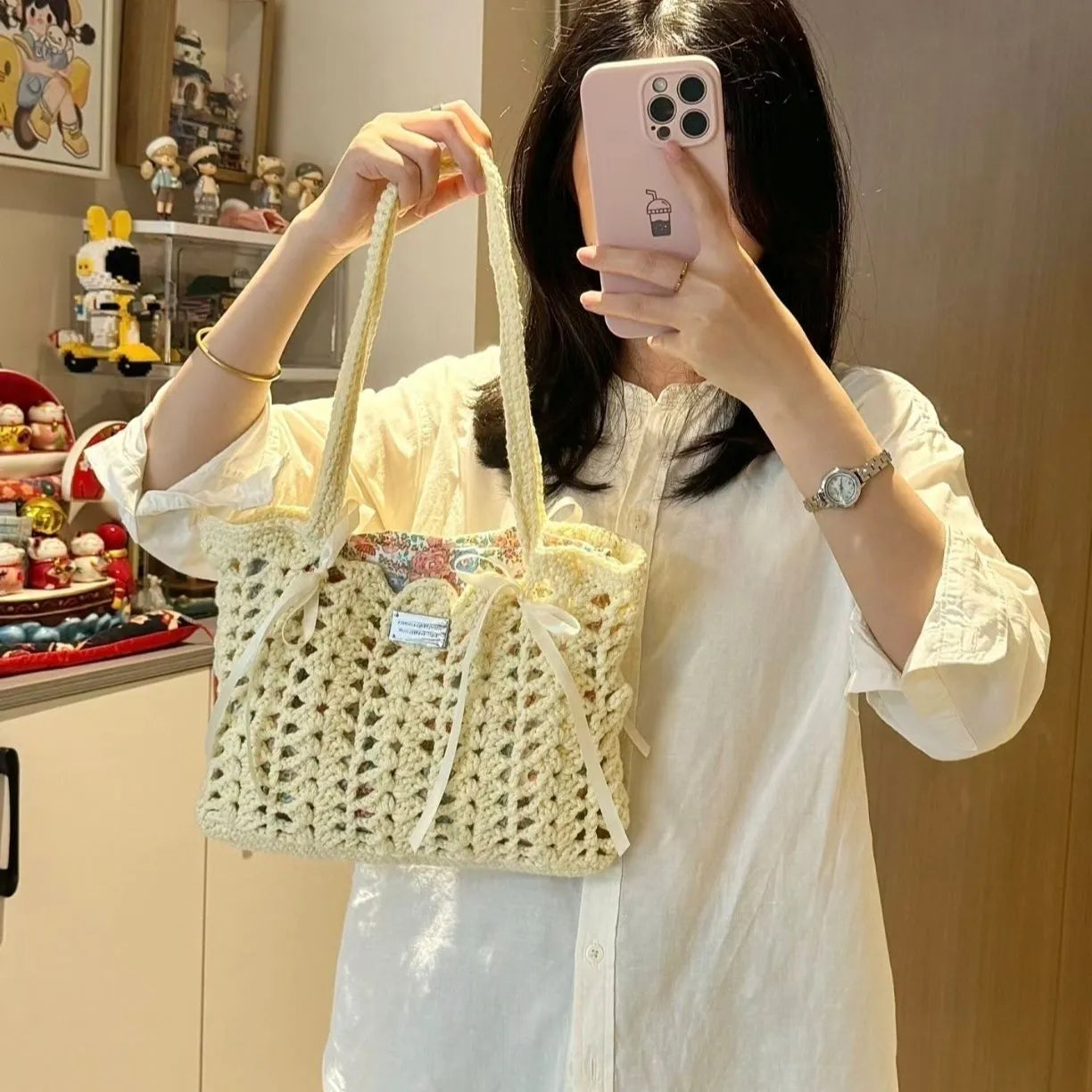 Handmade woven shoulder bag with a floral pattern, made from soft wool yarn.