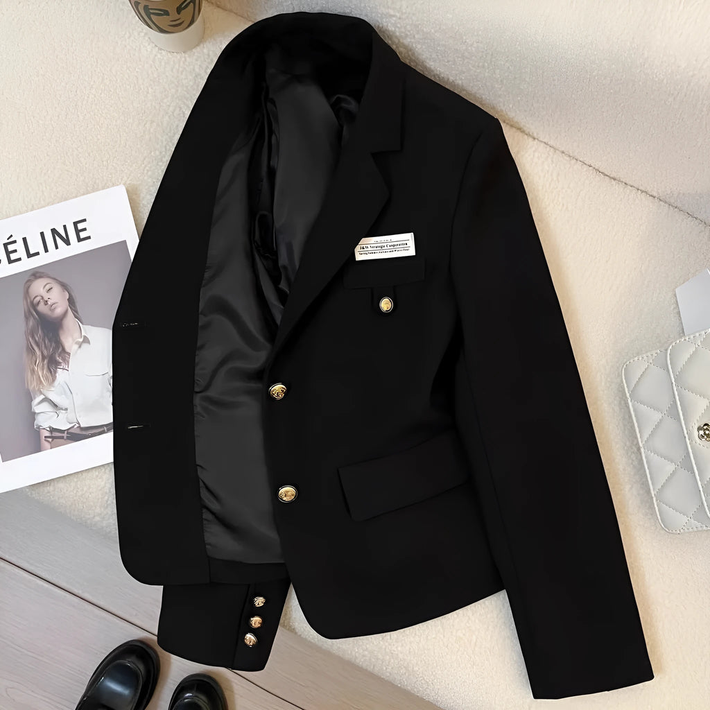 Women's black short suit coat with loose fit and pocket detail on hanger
