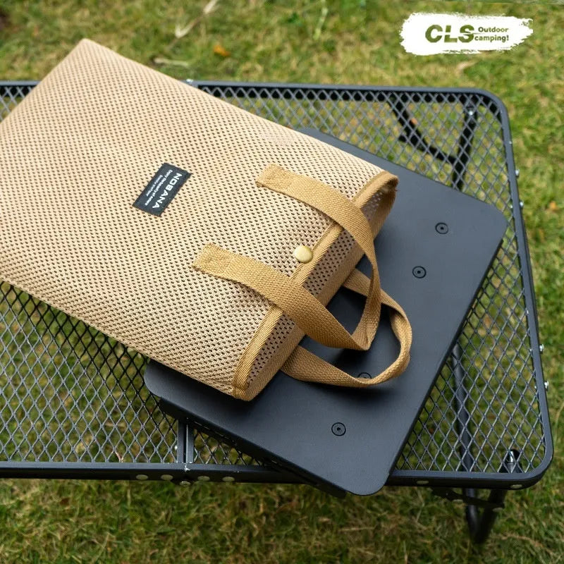 CLS aluminium dual-use camping stool shown in table mode with PU mat cushion, beside its storage bag.