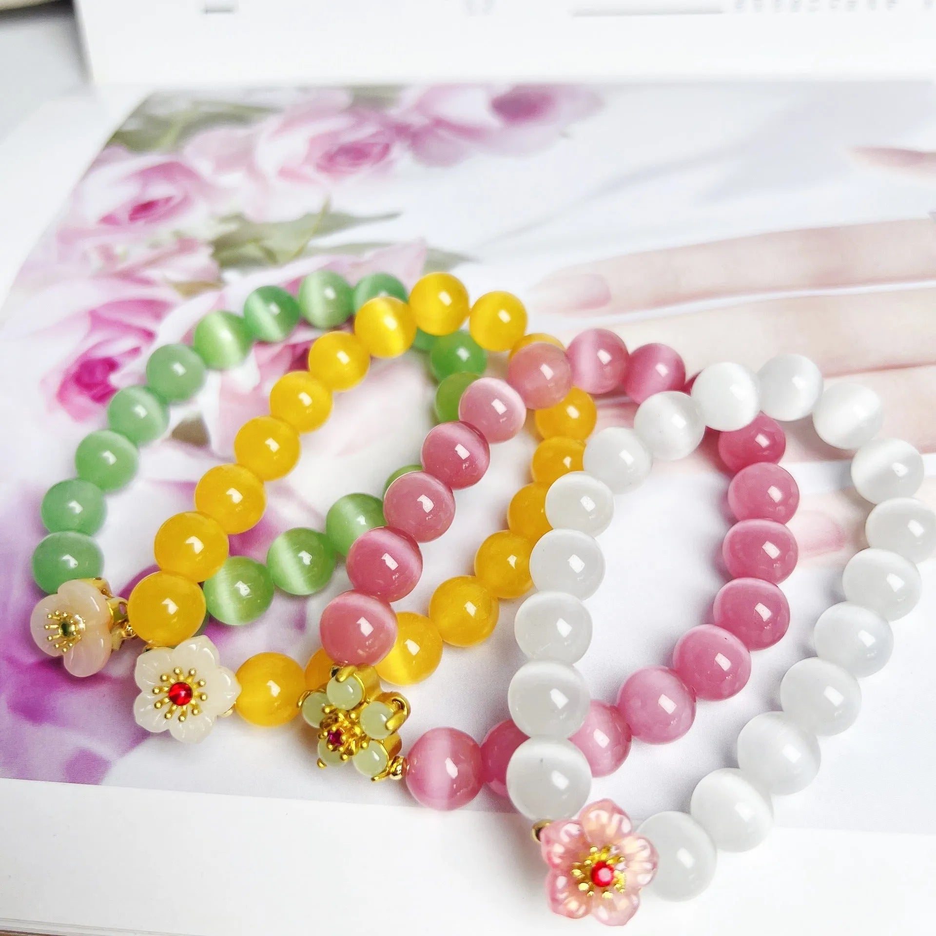 Handmade glass bead bracelet with flower design for women in yellow, pink, white, or green.