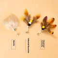 Three small flying insect-shaped cat toy heads on steel wire stems, in assorted colours.