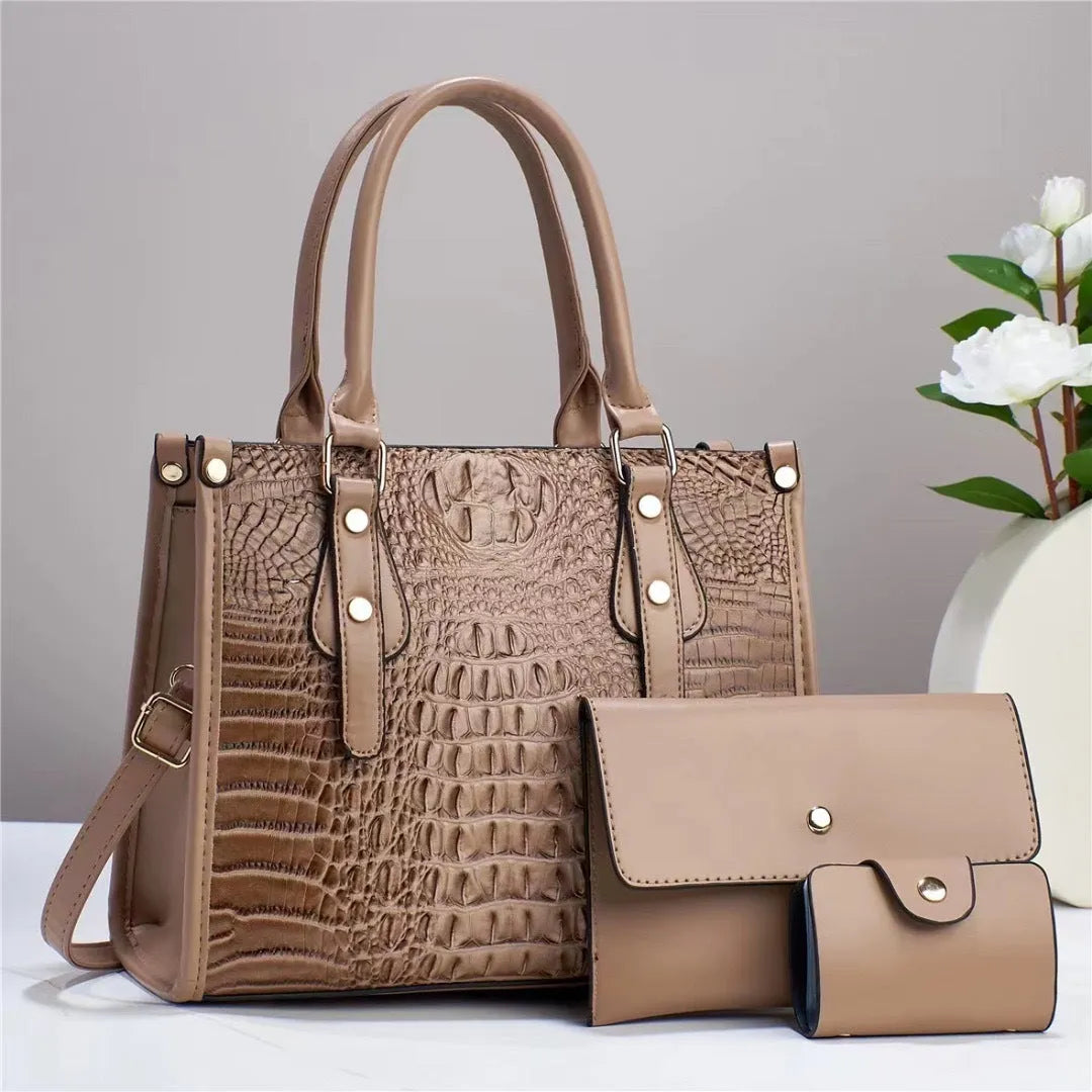 PU leather three-piece bag set in burgundy showing bucket crossbody bag, wallet, and card holder.