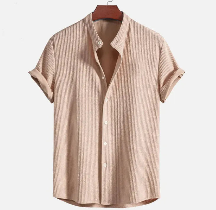 Men's loose fit short sleeve casual shirt in light blue, showing front view on a hanger.