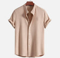 Men's loose fit short sleeve casual shirt in light blue, showing front view on a hanger.