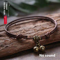 Nylon rope dog collar with brass buckle shown in black, red, and coffee colours, some with an attached brass bell.