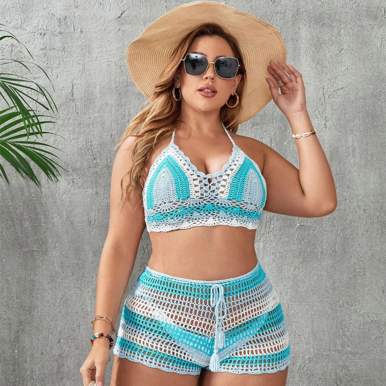Blue women's plus size hollow out strap split swimsuit briefs on a white background.
