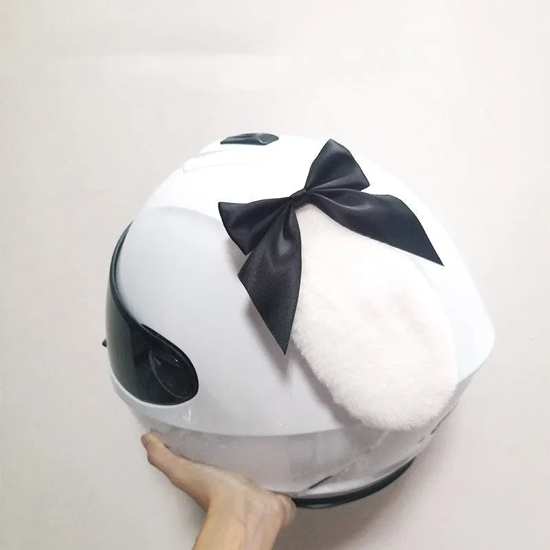 Carbon fibre rabbit ears decoration for a motorcycle helmet on a black background.