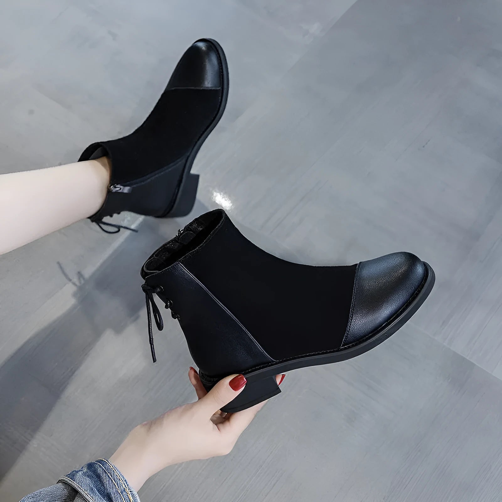 Women's black Martin boots with side zipper, non-slip rubber soles, and decorative bow detailing