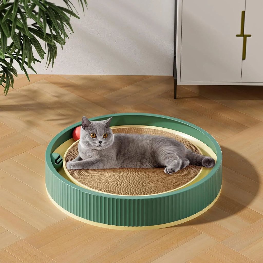 Large circular green cat scratching board with built-in ball toys and a replaceable cardboard core.