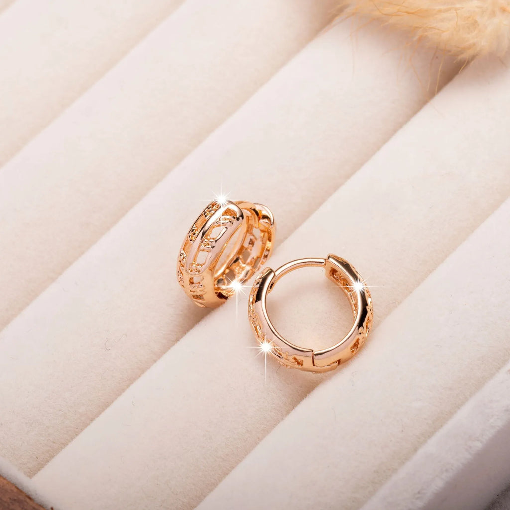 Rose gold plated copper stud earrings with hollowed leaf and heart design.