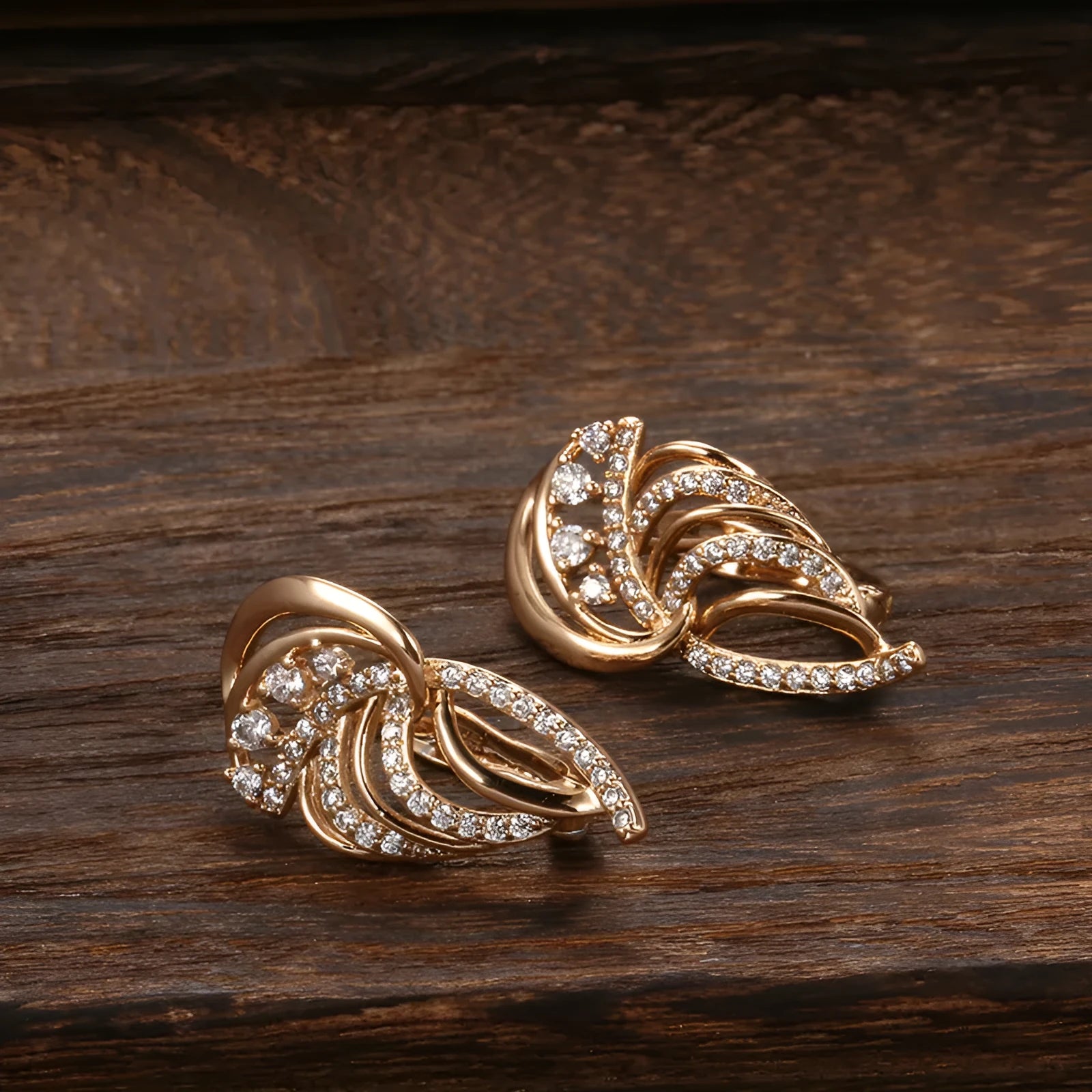 Gold geometric wing-shaped ear clips with micro inlaid stones on U-shaped copper clips