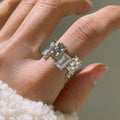 Silver geometric cross ring with open zircon stone setting.