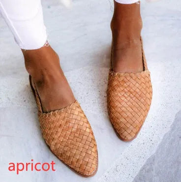 A pair of flat, pointed-toe sandals with a buckle fastening, shown in a choice of colours.