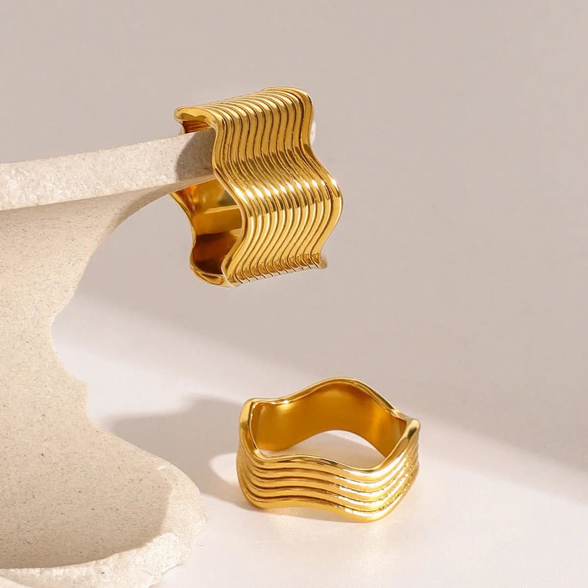 Women's stainless steel geometric ring with wide wave design in electroplated colours