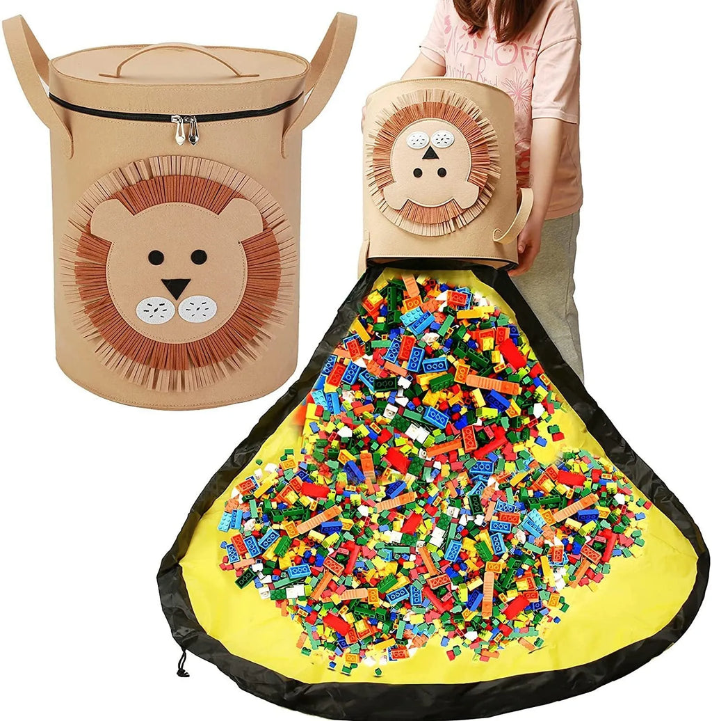 Green felt cube-shaped toy storage bag opened flat as a play mat next to toys, showing pull rope.