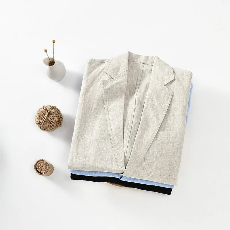 Men's thin linen suit coat in a solid colour on a hanger, showing stick pocket detail.