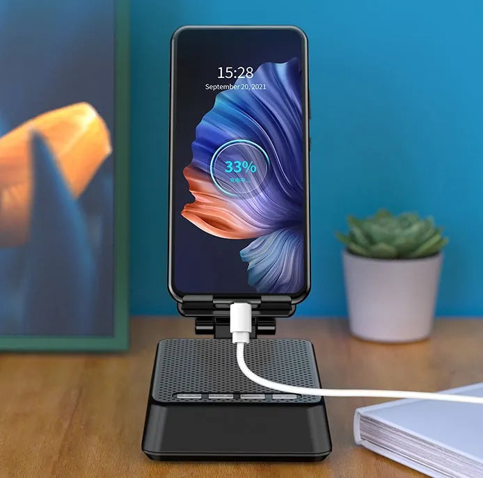 Black Bluetooth speaker phone stand with microphone for live streaming, showing phone holder and charging port