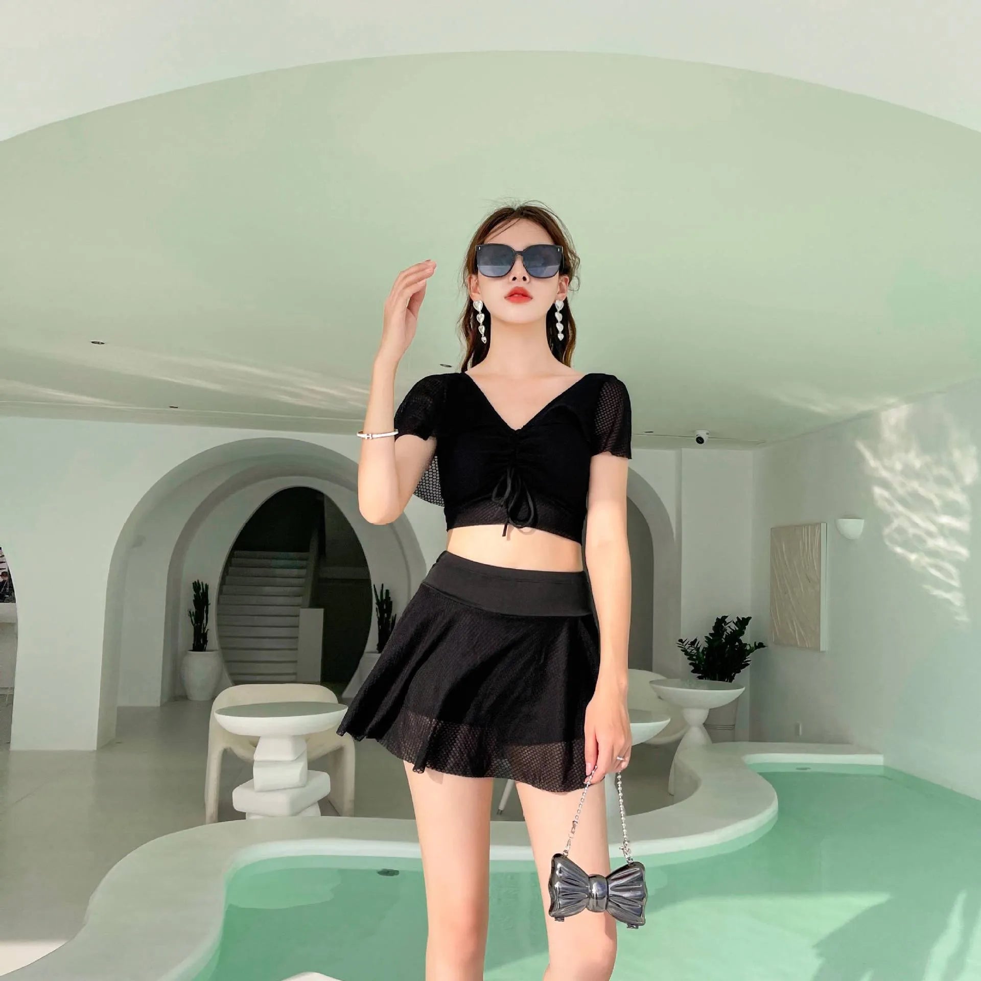 Women's solid colour two-piece skirt swimsuit set in black, white, or pink with separate top