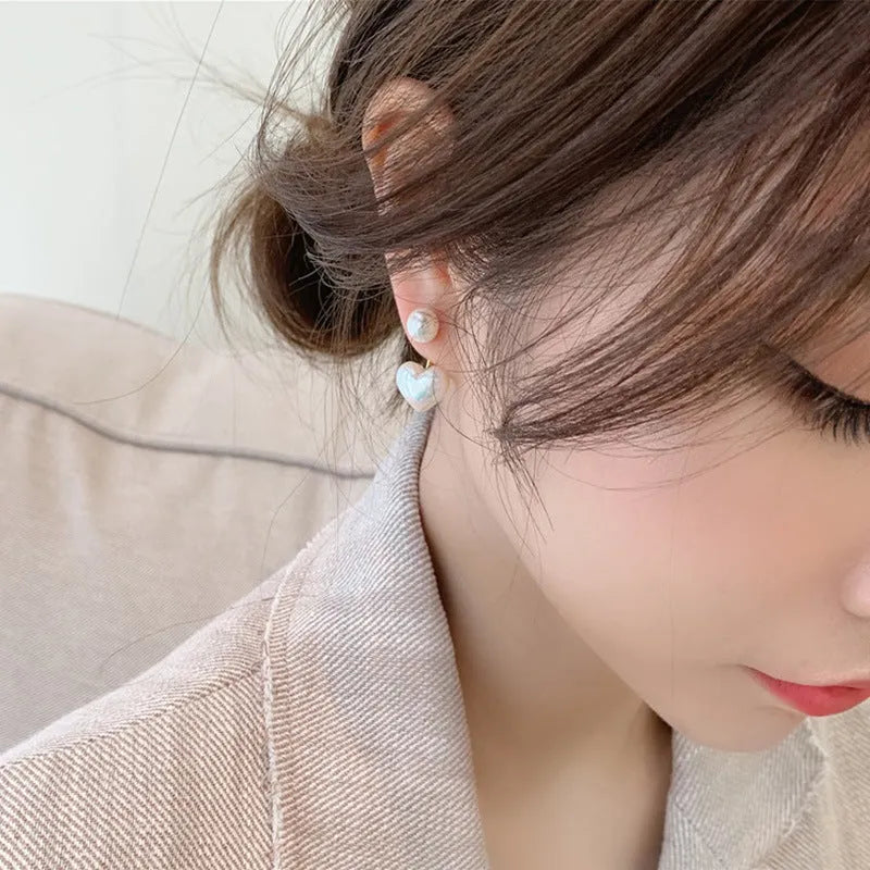 Heart-shaped stud earrings with pearlescent artificial gemstone accents on electroplated alloy