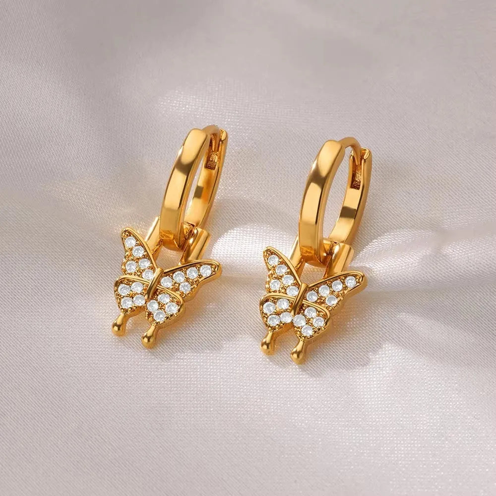 Women's copper butterfly earrings with geometric heart and star shapes.
