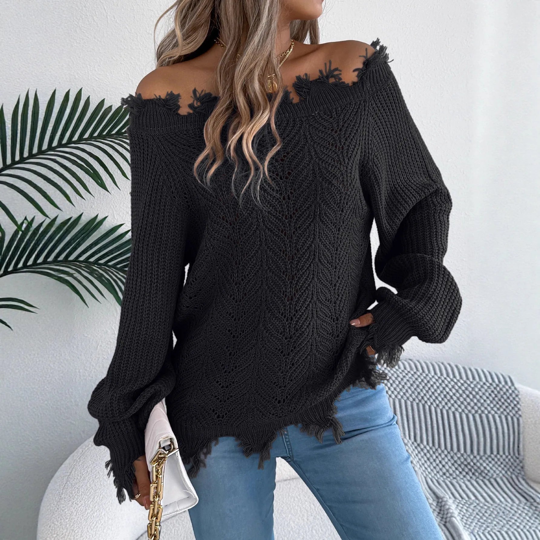 White women's off-the-shoulder pullover sweater with a hollow-out design and long sleeves.