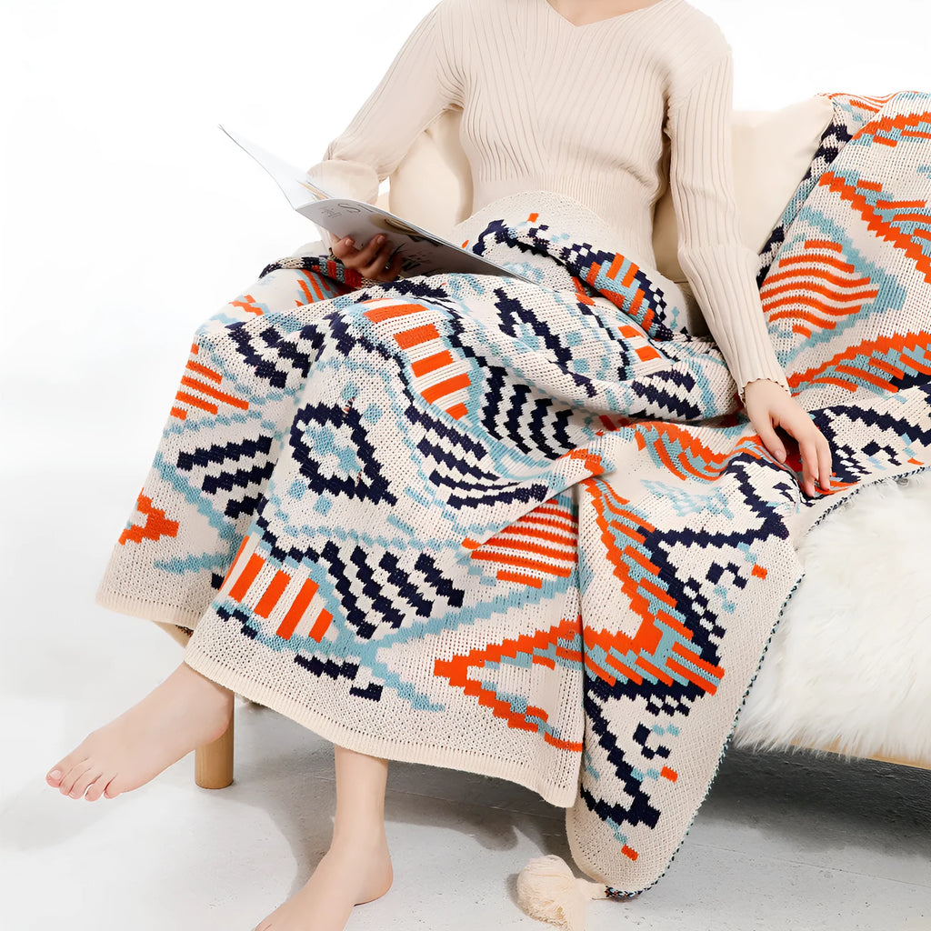 Acrylic bohemian-style blanket with tassel trim in a geometric pattern colour option