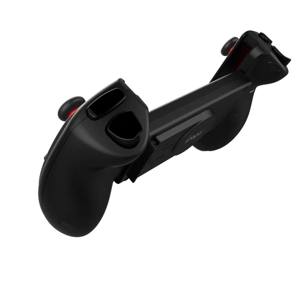 Red telescopic gamepad controller with USB cable on a dark surface.